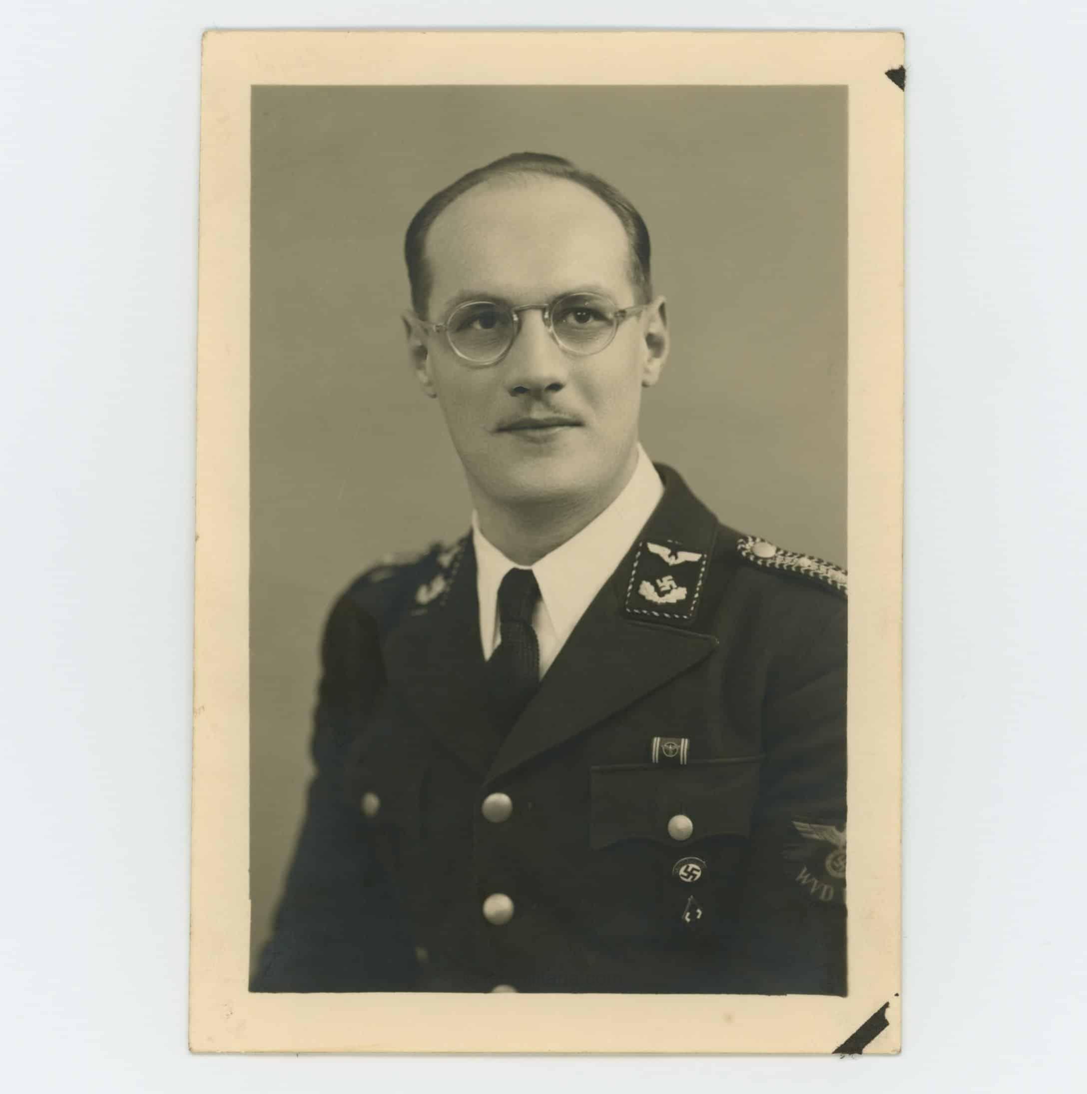 Postcard size portrait Reichsbahn offical with Gold HJ membership badge, NSDAP membership badge and NSDAP ribbon bar in wear.